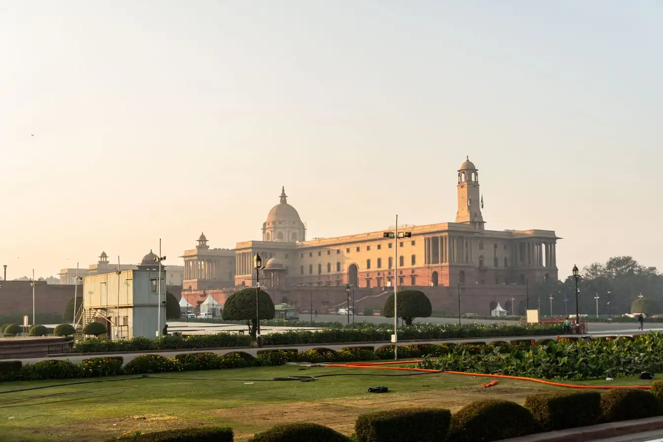 Rashtrapati Bhavan in New Delhi at sunrise under a clear sky.