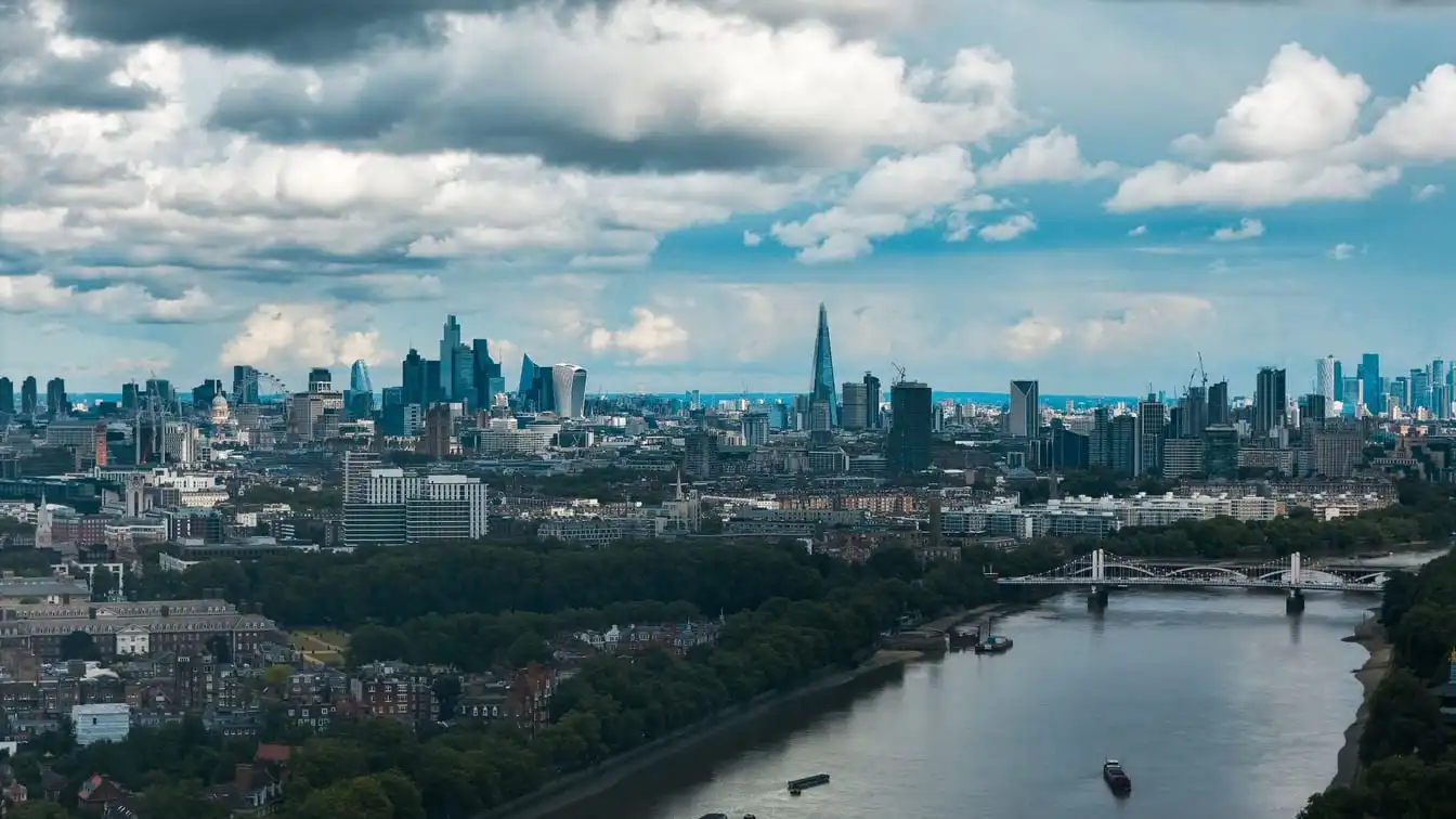 The London skyline and the River Thames under a dramatic sky.